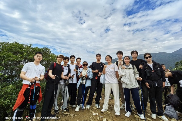 Lab members standing together on a mountain trail during an autumn trek