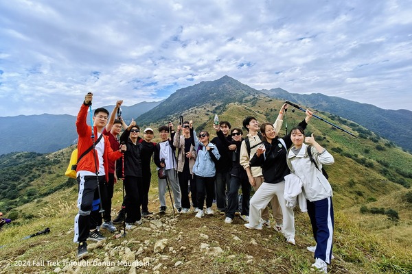 Lab members posing together near the end of a mountain trek