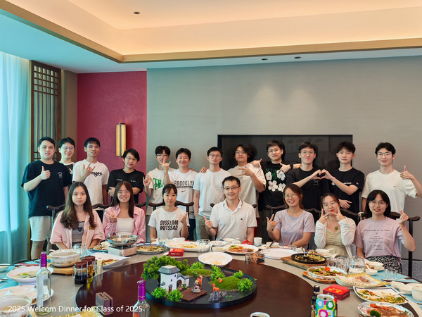 Lab members gathered around a restaurant table for a welcome dinner