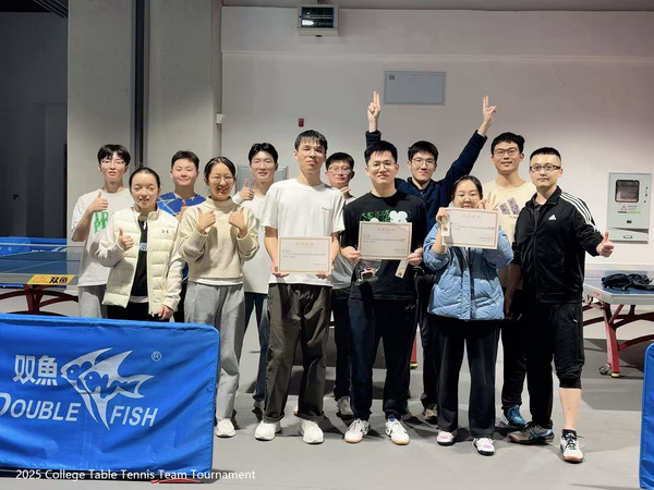 Team members holding table tennis paddles together inside a sports hall