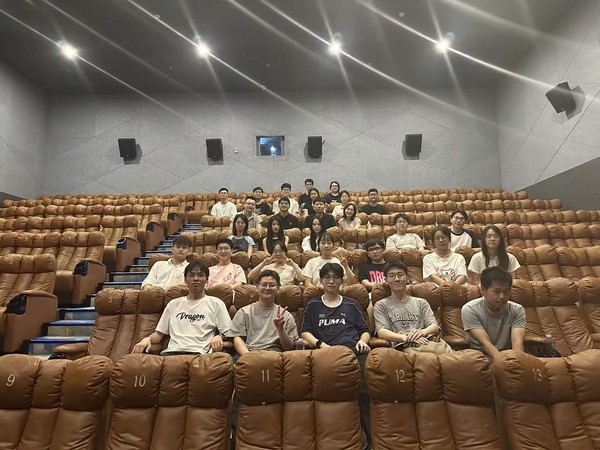 Members of the participating research groups seated together in a cinema.