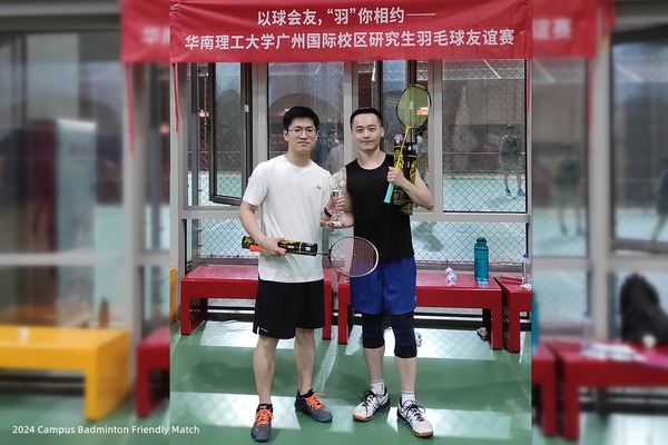 Lab members holding badminton rackets together inside a campus sports hall