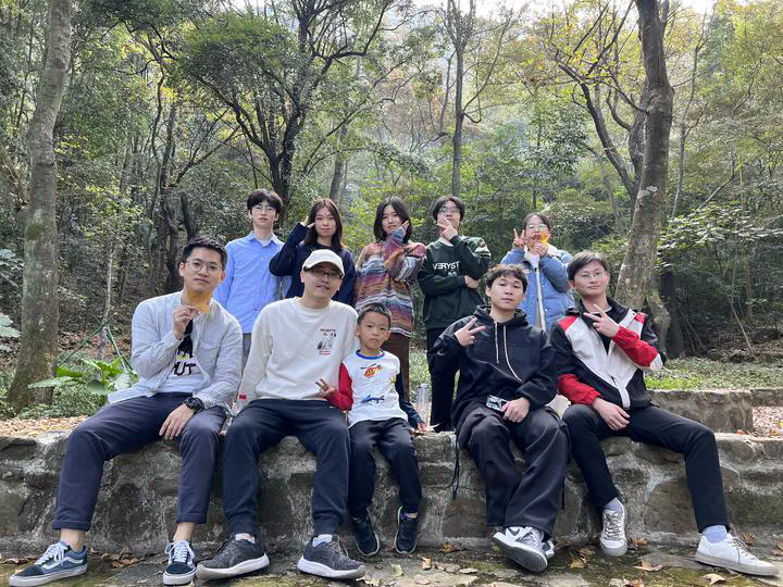 Group members posing among trees during the Shimen camping trip.