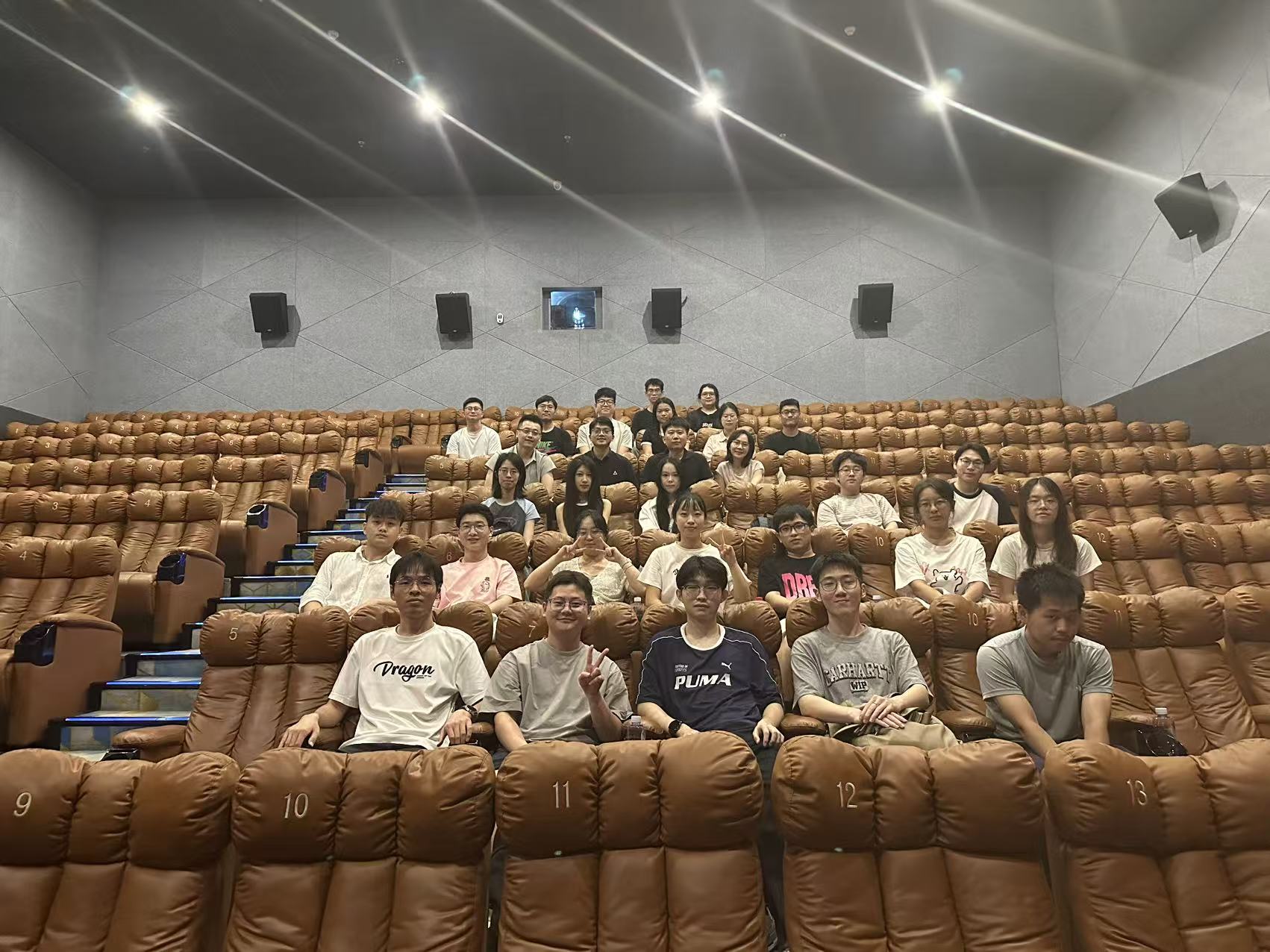 Members of the participating research groups seated together in a cinema.