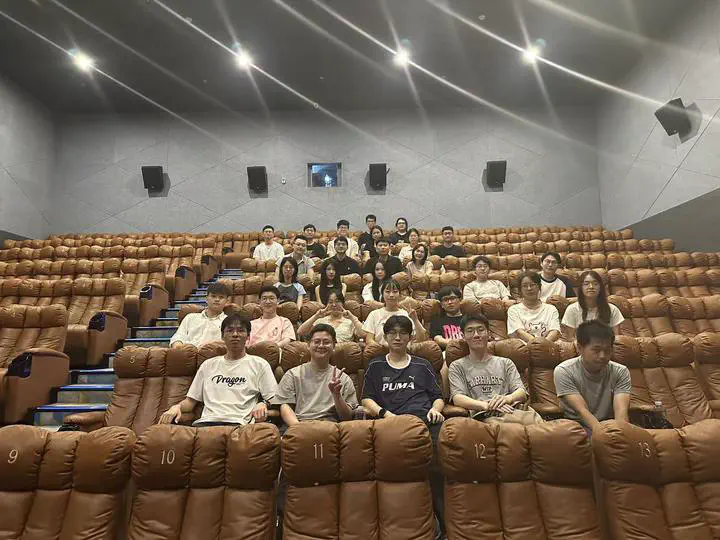Members of the participating research groups seated together in a cinema.